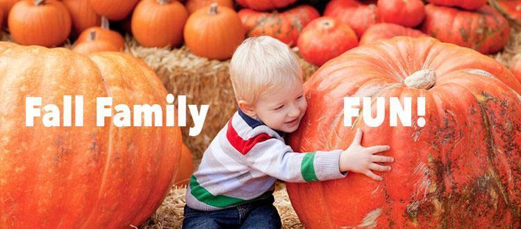 Fall family fun: a child in a pumpkin patch embraces a great pumpkin
